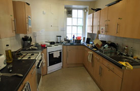 A kitchen with two ovens and hobs, two sinks and lots of cupboards and drawers.