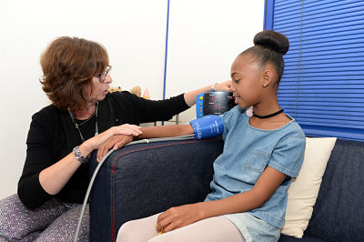 10-year-old COCO90s Scarlet having her blood pressure measured