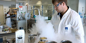 A researcher conducting an experiment in a lab