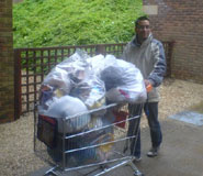 An image of Bristol University SCA volunteer with a trolley of collected items.