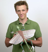Koen Stein holding a model Kuehneosaur.