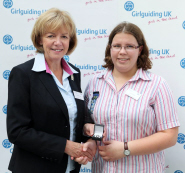 Chief Guide Gill Slocombe presents the Queen's Guide Award to winner Clare Cooper