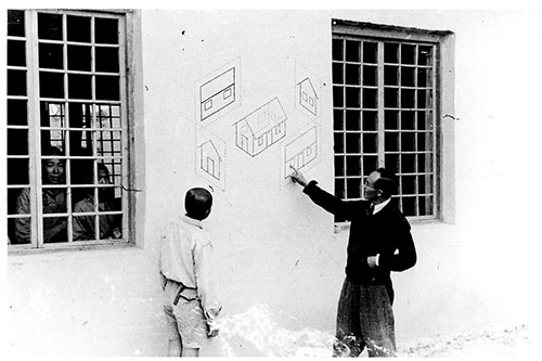 Image of Zhang Guanlian explaining some simple architectural drawing to a student at the Lanchow Bailie School, 4 Sept. 1943