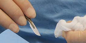 close up of surgeon with scalpel in hand