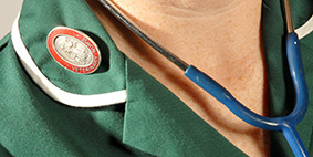 close up of vet nurse in uniform wearing stethoscope around neck